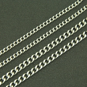 Macro detail of four parallel silver curb chains with polished metallic finish and links