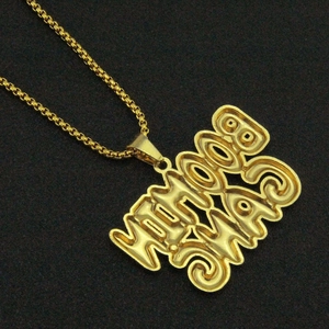 Close-up of 3D gold YOMAMA letter pendant with iced out rhinestones on box chain