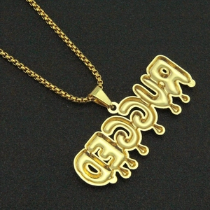 Detail of gold box chain and RICED drop style pendant with cubic zirconia stones