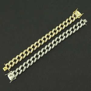Detail of gold and silver Cuban chain bracelets with full zircon pave and flat buckle