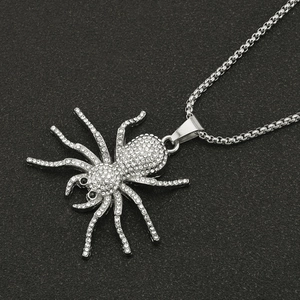 Iced out silver spider pendant necklace with sparkling crystals and black stone eyes