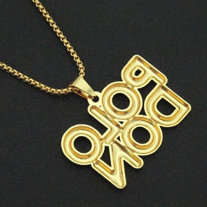 Detailed macro view of a gold hip hop letter pendant with a matching box chain accessory