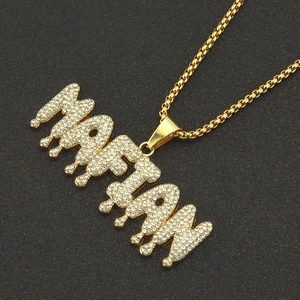 Hip hop style gold plated MARIAN pendant necklace with iced out stones on black background