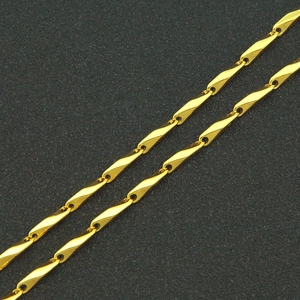 Minimalist gold-tone bamboo link chain necklace with high-polish finish on dark background