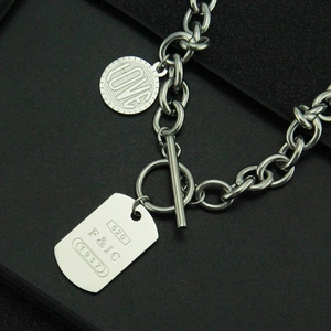 Détail du collier en acier inoxydable argenté avec fermoir OT et pendentif rectangulaire