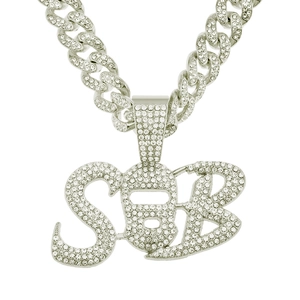 Close-up of iced out Cuban link chain with a ski mask face and SB letter pendant