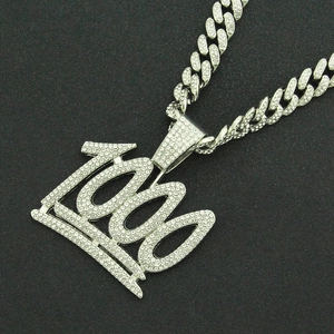 Close-up of hip hop necklace with iced out number 1000 pendant and silver crown detail