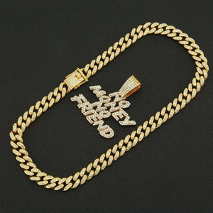 Macro shot of iced out Cuban link chain with gold NO MONEY NO FRIEND letter pendant