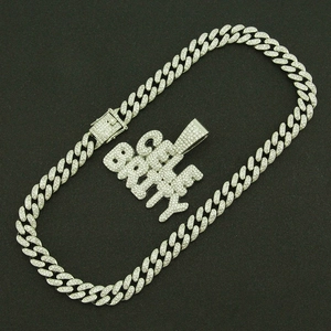 Macro detail of iced-out silver Cuban chain and CELEBRITY letter pendant with rhinestones