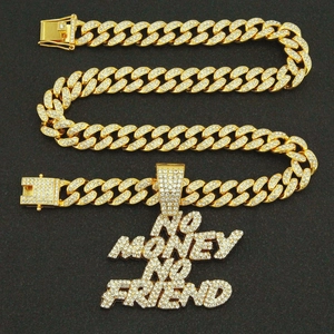 Close-up of gold iced out No Money No Friend letter pendant with iced out Cuban link chain