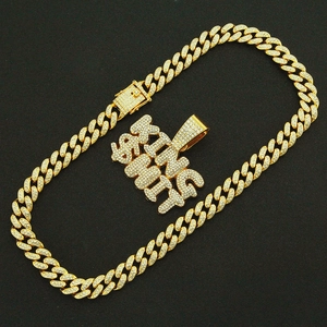 Detail of hip hop gold Cuban chain necklace with iced out KING SHIT letter pendant