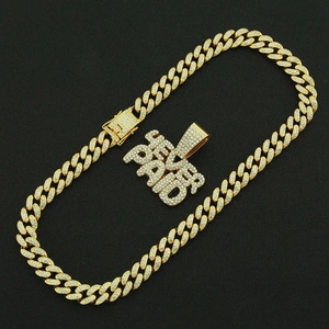 Detail of gold Cuban chain necklace with iced-out FEVER PAID letter pendant on black background