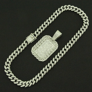Close-up of iced-out silver Cuban link chain and large rectangular military dog tag pendant