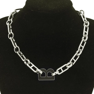 Silver chunky chain necklace with bold black B letter pendant on black mannequin