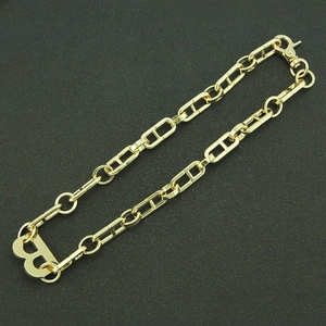 Detailed view of golden H-link chain necklace with bold letter B pendant and lobster clasp