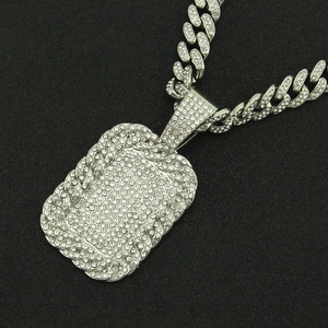 Iced out hip hop dog tag pendant with heavy diamond-studded Cuban link chain in silver