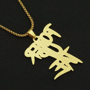 Macro shot of gold-plated TRUST letter pendant with iced-out texture on box chain