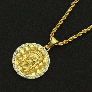 Golden Jesus medallion pendant necklace with cubic zirconia on a black textured background