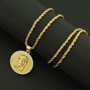 Close-up of gold pharaoh pendant with pavé rhinestones on black display