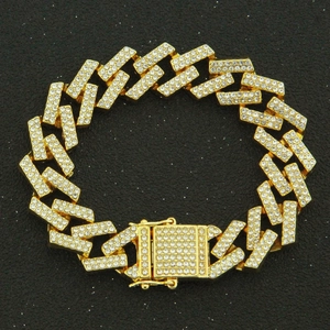 Detailed view of the 15mm gold Cuban link bracelet with iced out stones and magnetic clasp