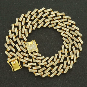 Close-up of hip-hop gold plated Cuban link chain with paved rhinestones and box clasp