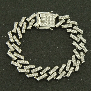 Close-up of 15mm iced-out Cuban link bracelet with sparkling rhinestones on black background