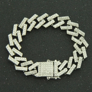 Macro detail of silver hip-hop Cuban link bracelet with sparkling pave diamonds