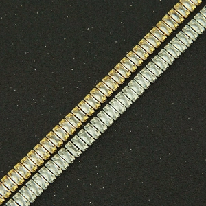 Macro view of gold and silver cuban chain links with baguette-cut zircon pavé stones