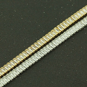 Detail of gold and silver tennis chains with baguette-cut zircon in a parallel view