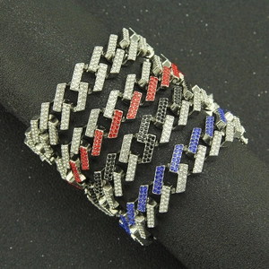 Detail of multi-color hip hop Cuban bracelets with rhinestones on black display