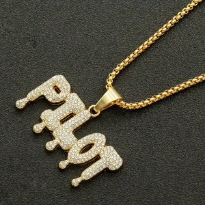 Iced out gold PILOT pendant necklace with drip font and cubic zirconia inlays