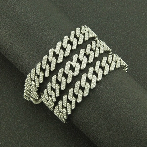 Macro detail of silver-colored Cuban link necklace with sparkling pavé-set rhinestones