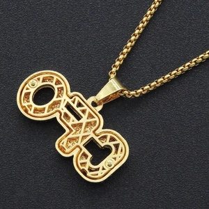Close-up of golden OTF letter pendant with hollow geometric hip hop design on box chain