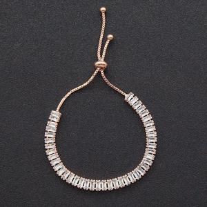 Detail of rose gold adjustable bracelet featuring baguette-cut zircon crystals and bolo clasp