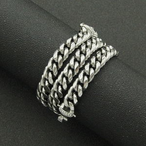 Polished silver cuban link chain with sparkling rhinestone buckle on black display