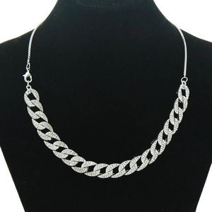 Detailed view of silver Cuban link necklace with rhinestones on black jewelry bust