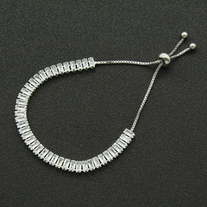 Adjustable silver bracelet with rectangular cubic zirconia stones on black background