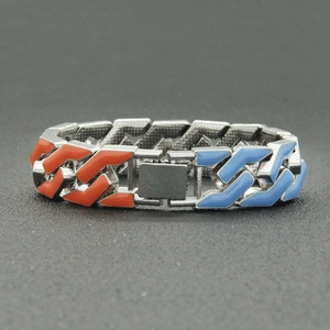 Detail of multi-color enamel inlay on silver Cuban link bracelet with square clasp