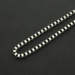 Detailed close-up of polished silver punk double-layered box chain with metallic texture