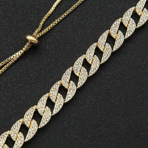 Close-up of gold iced out Cuban chain necklace with sparkling crystals and adjustable slide clasp