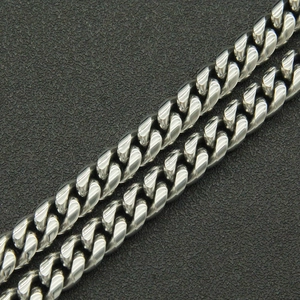 Detailed macro view of high-polished silver stainless steel Cuban link chain necklace