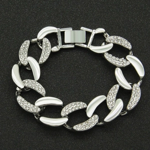 Close-up of silver-tone chunky Cuban link bracelet with sparkling rhinestones and clasp