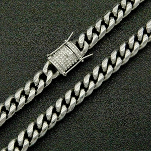 Close-up of a silver Cuban link chain featuring a luxury micro-pave diamond box clasp