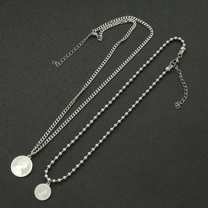 Layered silver coin necklace set with portrait pendants in polished stainless steel