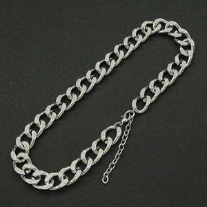 Close-up of silver Cuban chain necklace with pave-set rhinestones and lobster clasp