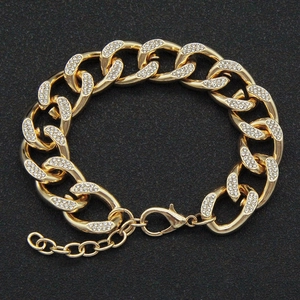 Detailed view of a gold Cuban link chain with sparkling pavé-set rhinestones and clasp