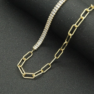 Trendy gold paperclip necklace with sparkling baguette-cut zirconia in a dual-chain style
