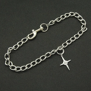 Silver Cuban chain necklace with a four-pointed star pendant and zircon on black background