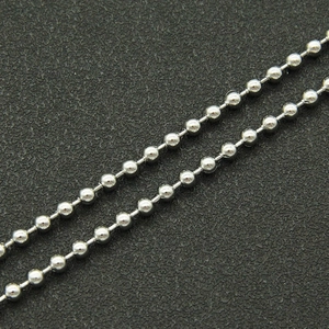 Macro close-up of polished silver ball chain links with metallic finish for necklaces