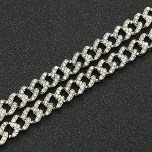 Close-up of silver Cuban link chain with iced out crystal pavé setting for hip hop style